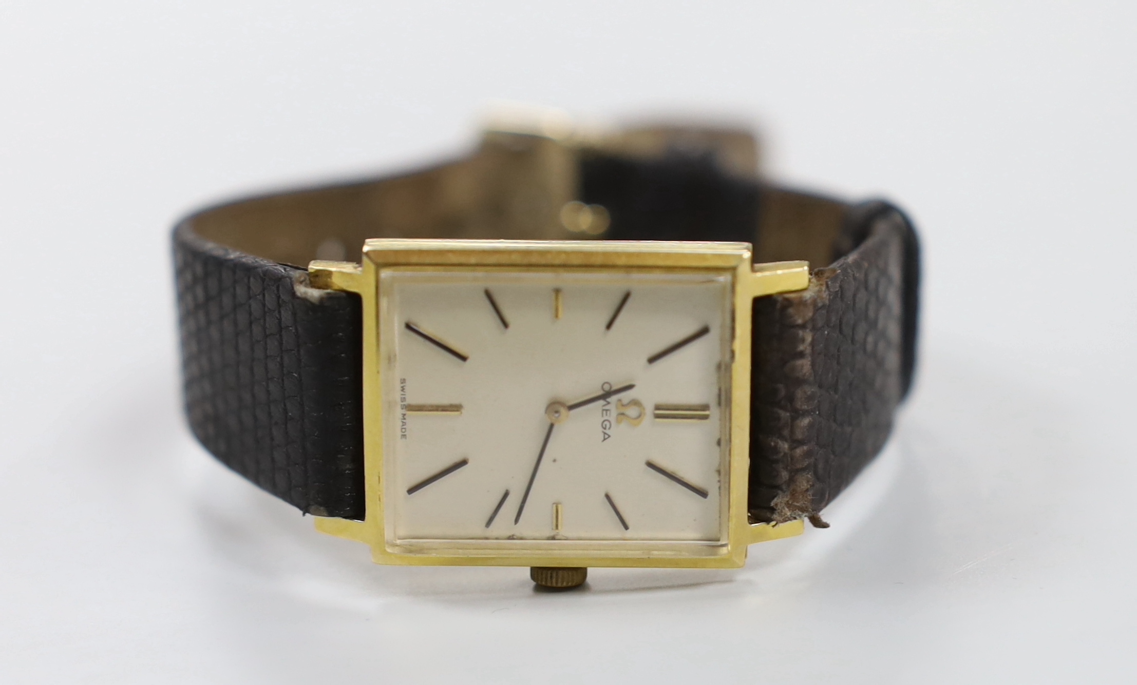 A gentleman's 18k Omega manual wind rectangular dress wrist watch, on associated leather strap, case diameter 24mm, no box or papers.